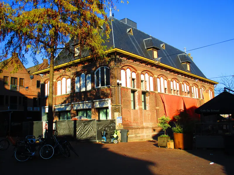 Historisch pand aan de Korenmarkt in de Arnhemse binnenstad, met bomen en fietsen ervoor